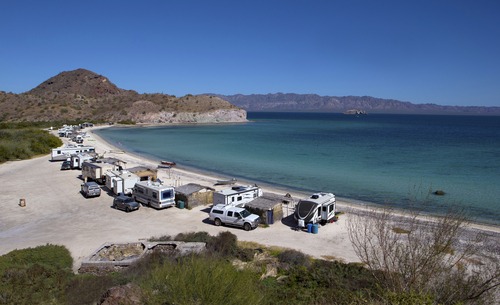 trailers and RVs parked on a beach