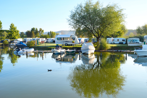 RV's & trailers along waterfront with boats