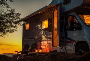 RV parked at camp at sunset