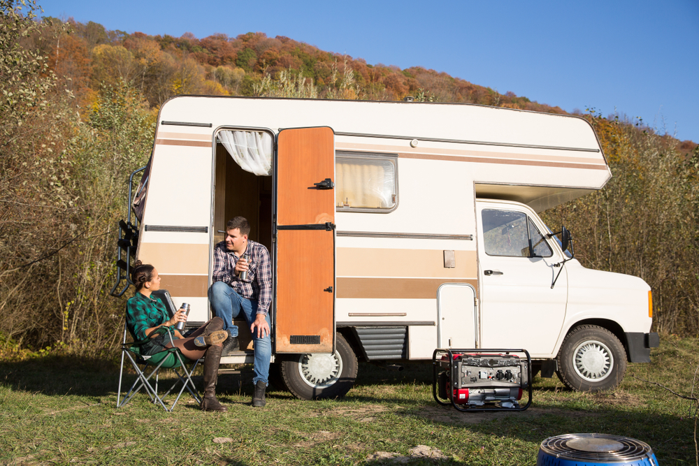 people with RV trailer at campsite