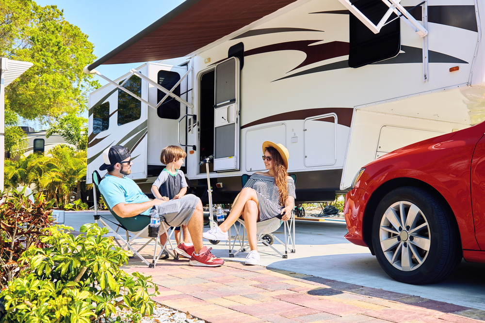 people with RV trailer at campsite