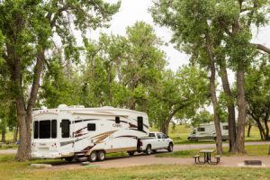 fifth wheel shown parked in a campground