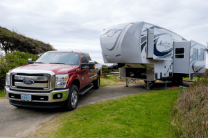 red pickup truck unhitched from a 5th wheel trailer 