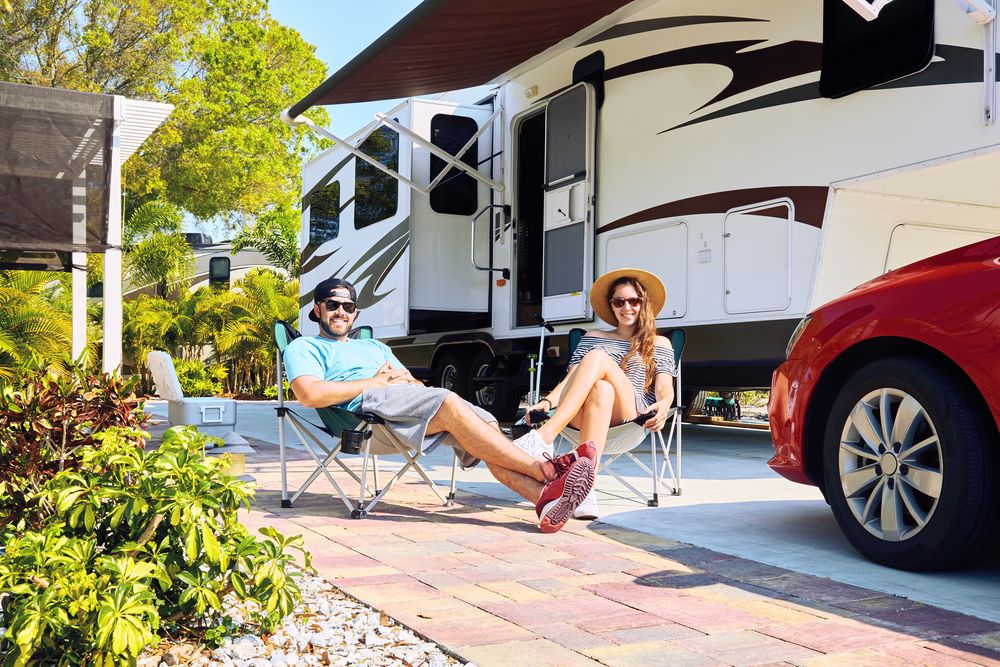 family couple with rv trailer